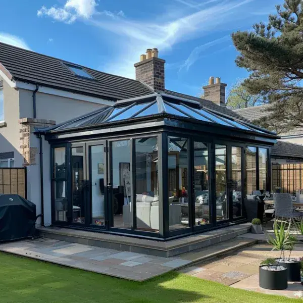 Modern black-framed conservatory roof extension photographed for Ultimate Home Solutions in Glasgow