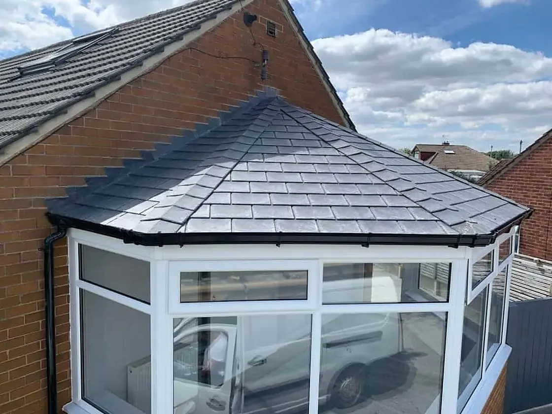 Victorian-style conservatory with a grey tiled roof photographed for Ultimate Home Solutions in Kilmarnock